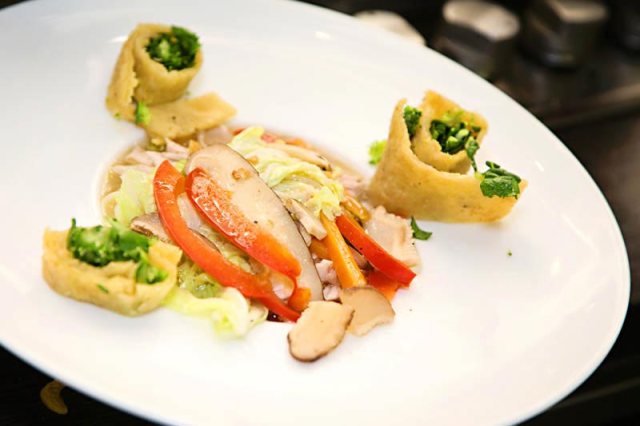 Dallas's take on chef Dewald's chicken noodle soup included sliced roti stuffed with greens on the side. 